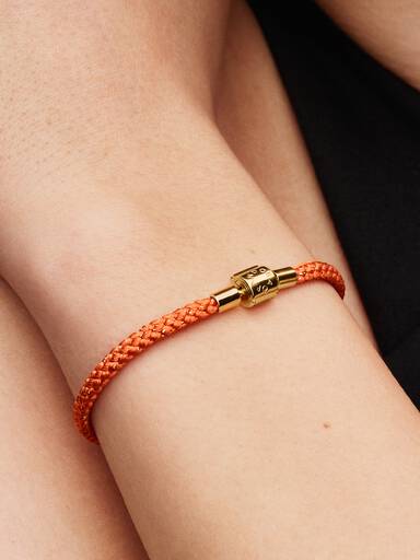 Skimrande orange textilarmband