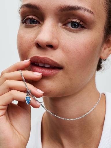Hängberlock med feminin symbol och blå artificiell opal