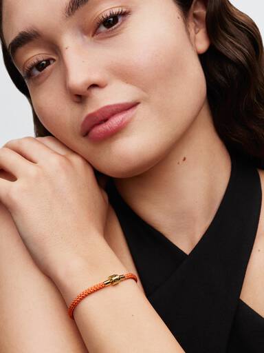 Skimrande orange textilarmband